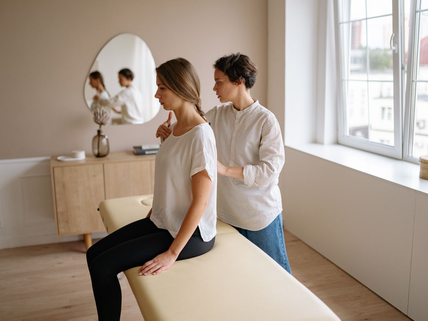 A practitioner and client during a shoulder massage.